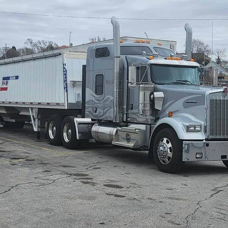 Silver trucks with dump trailers